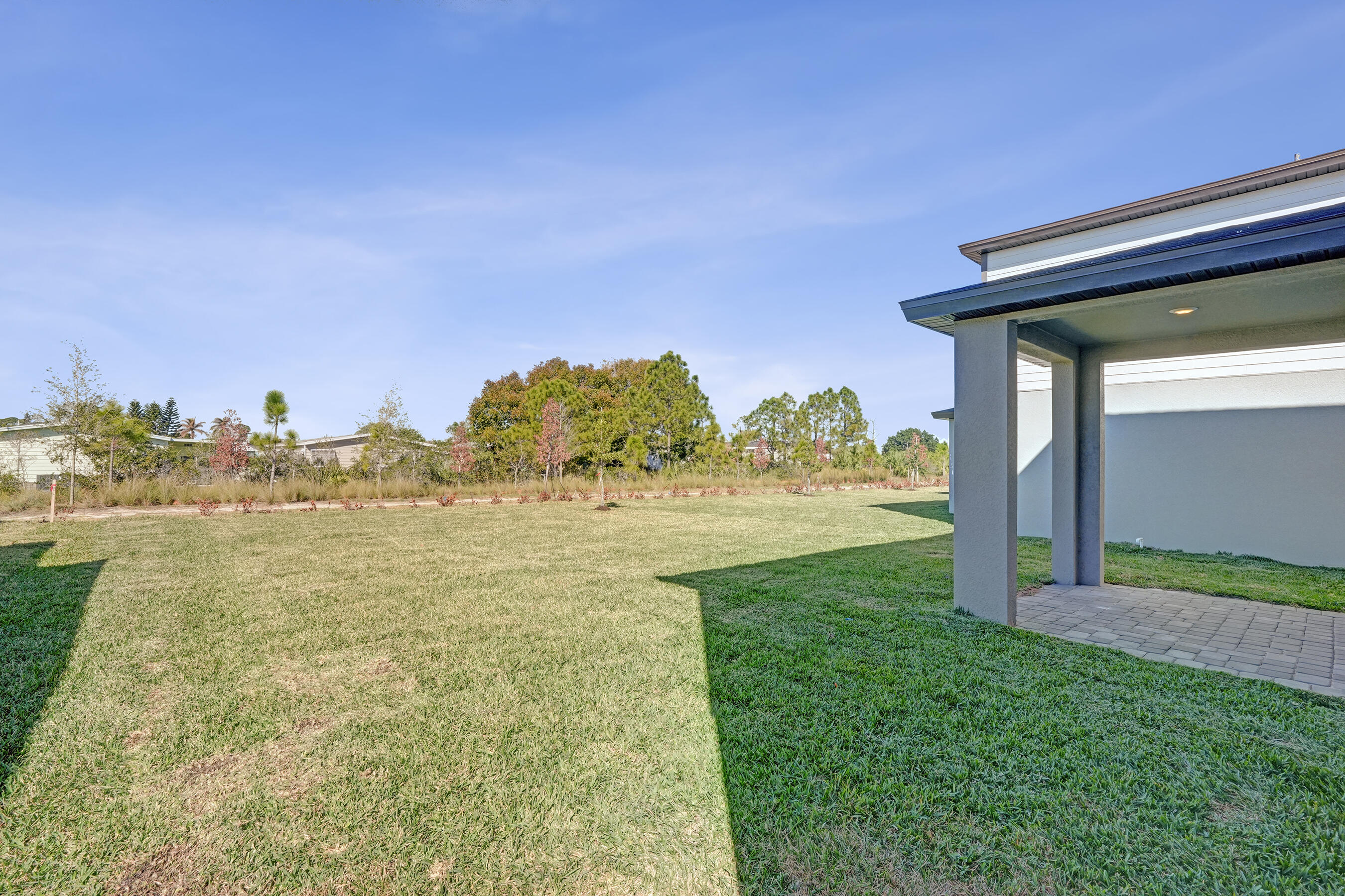 14308 Southwest New Dawn Road Indiantown, FL 34956 - Photo 24 of 25 a view of a pathway both side of building
