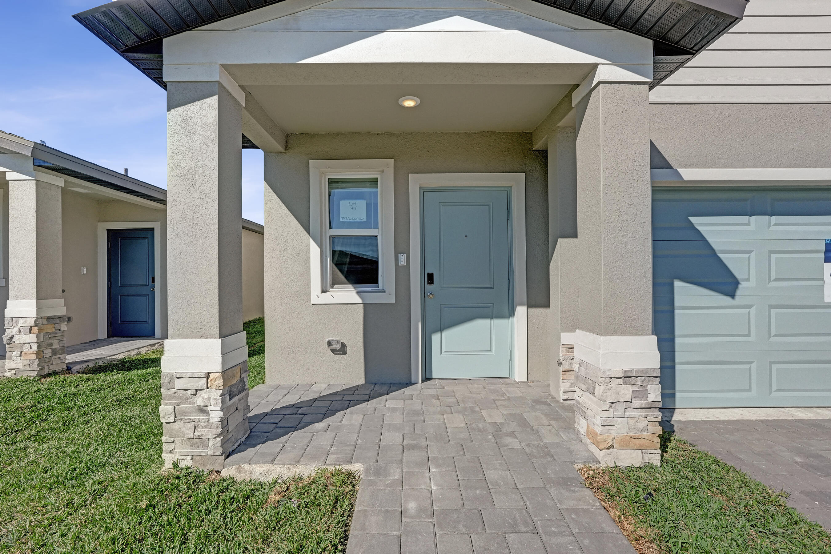 14308 Southwest New Dawn Road Indiantown, FL 34956 - Photo 3 of 25 a front view of a house with a yard