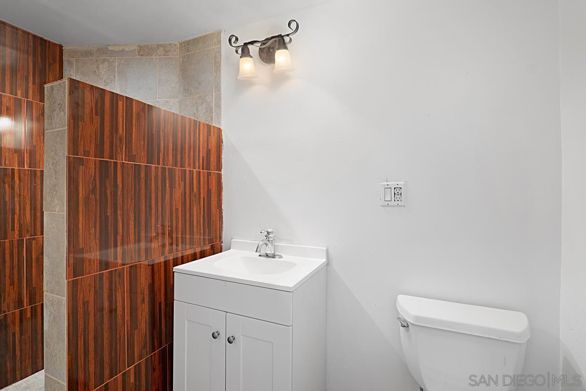 2756 Mission Road Fallbrook, CA 92028 - Photo 21 of 39 a bathroom with a sink a toilet and shower