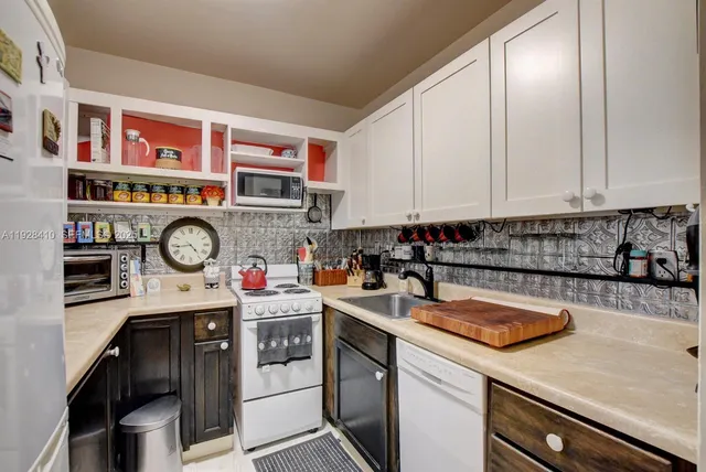 a kitchen with stainless steel appliances granite countertop a sink and cabinets
