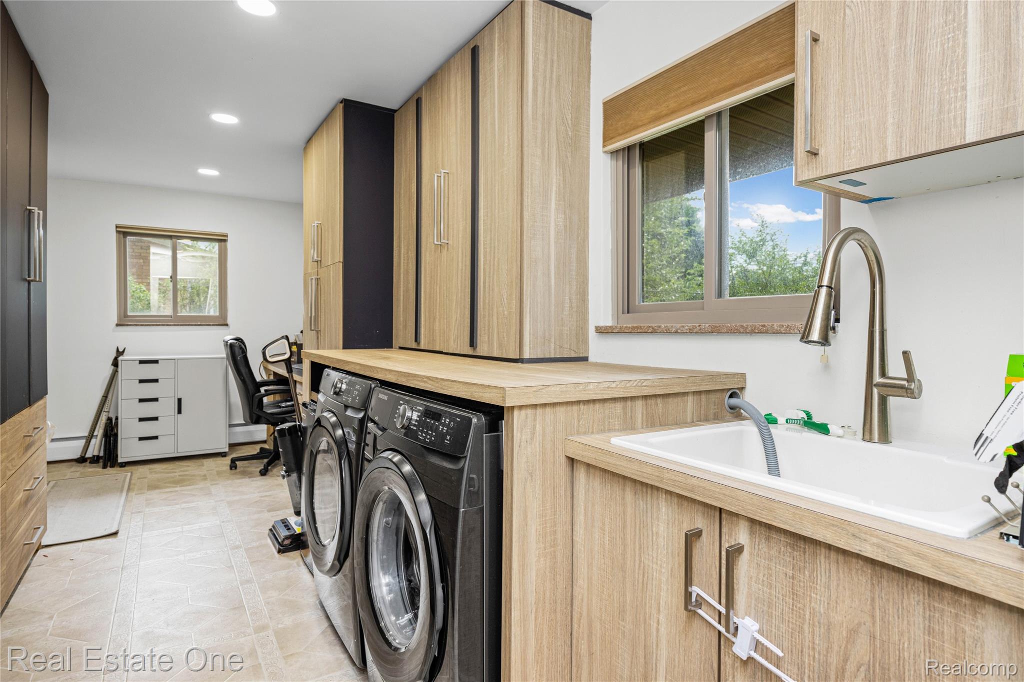 2810 Walbridge Drive Rochester, MI 48307 - Photo 23 of 58 Laundry room featuring integrated appliances, light wood-finish cabinetry, a utility sink with a gooseneck faucet, tiled flooring, and recessed lighting