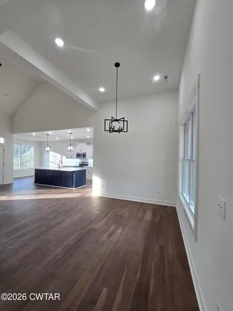 a view of a room with wooden floor and window