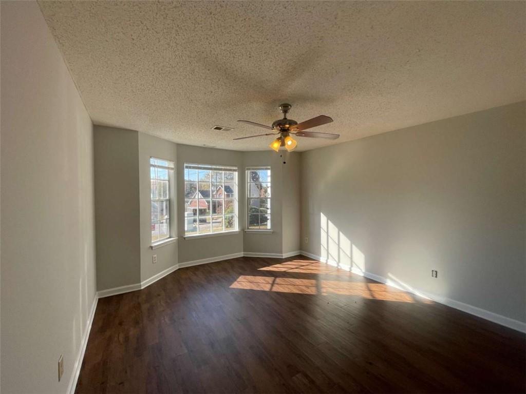 6387 Seths Way Lithonia, GA 30058 - Photo 16 of 44 a view of an empty room with wooden floor and a window