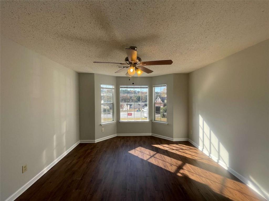 6387 Seths Way Lithonia, GA 30058 - Photo 17 of 44 a view of empty room with wooden floor and fan