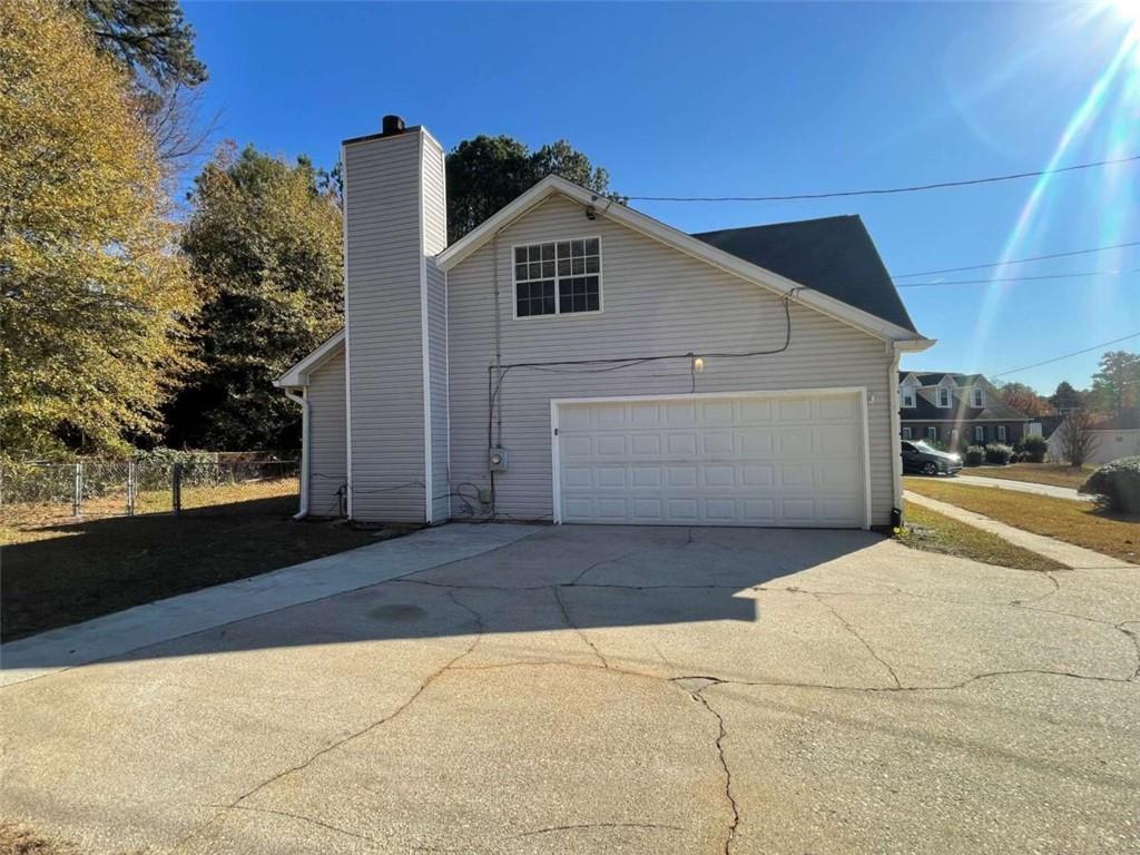 6387 Seths Way Lithonia, GA 30058 - Photo 2 of 44 a front view of a house with a yard and garage