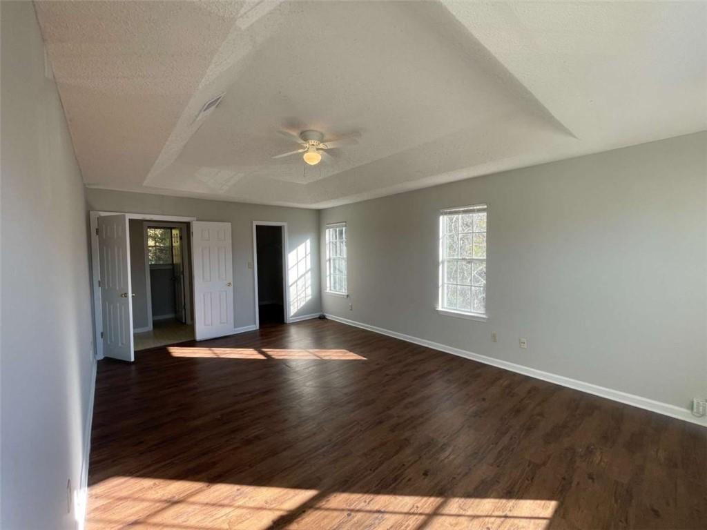 6387 Seths Way Lithonia, GA 30058 - Photo 23 of 44 an empty room with wooden floor and windows