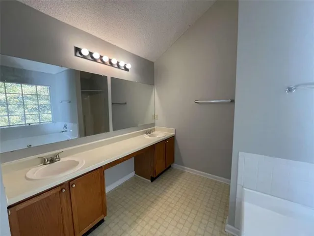 a bathroom with a sink a vanity and a mirror