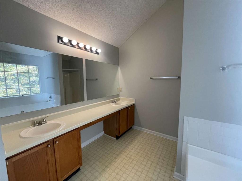 6387 Seths Way Lithonia, GA 30058 - Photo 26 of 44 a bathroom with a sink a vanity and a mirror