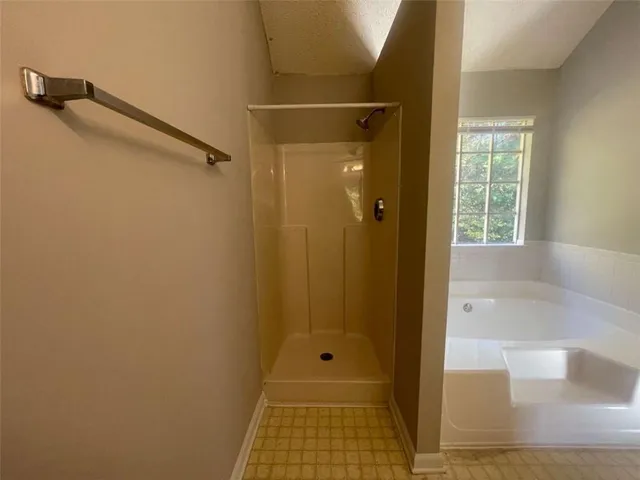 a bathroom with a glass shower door