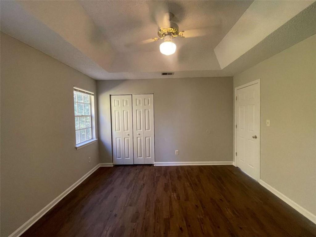 6387 Seths Way Lithonia, GA 30058 - Photo 36 of 44 an empty room with wooden floor and windows