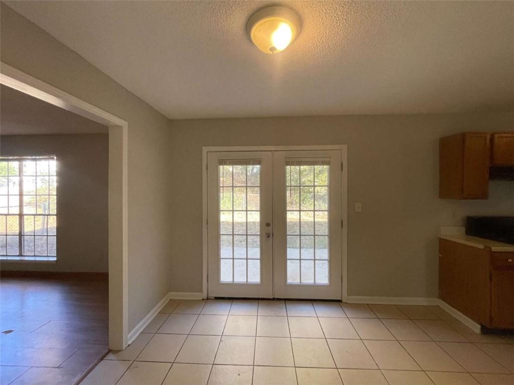 6387 Seths Way Lithonia, GA 30058 - Photo 4 of 44 a view of an empty room with a window and wooden floor