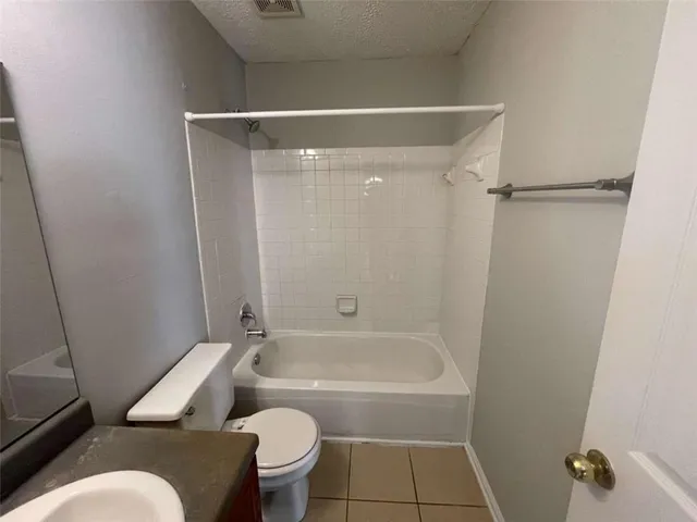 a bathroom with a toilet and a bathtub