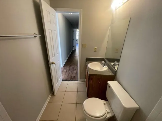 a white toilet sitting next to a bathroom sink