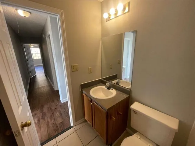a bathroom with a sink a toilet and mirror