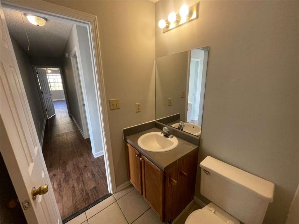 6387 Seths Way Lithonia, GA 30058 - Photo 43 of 44 a bathroom with a sink a toilet and mirror