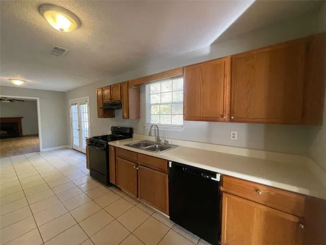a kitchen with a sink cabinets and window
