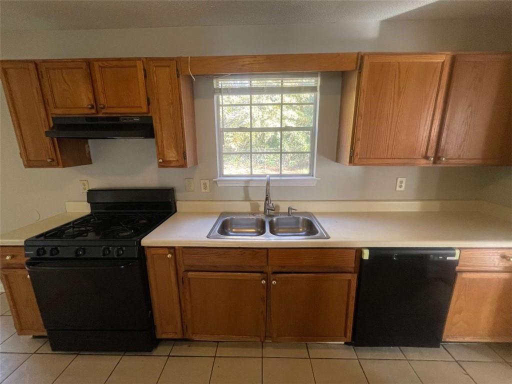 6387 Seths Way Lithonia, GA 30058 - Photo 9 of 44 a kitchen with a sink and a stove