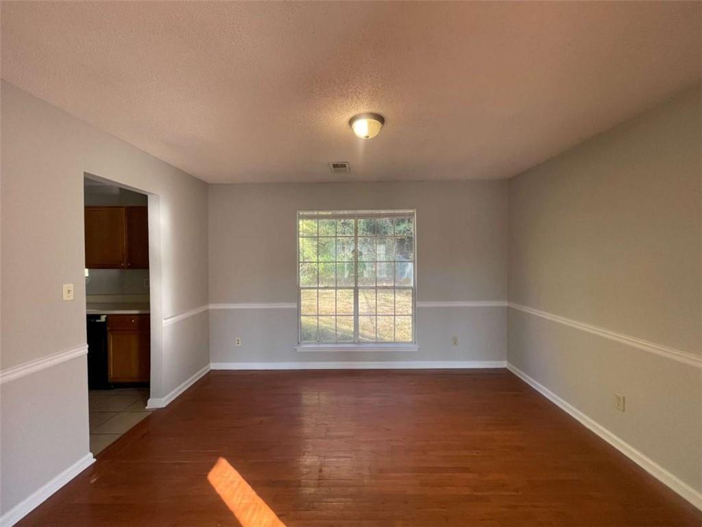 6387 Seths Way Lithonia, GA 30058 - Photo 10 of 44 wooden floor in an empty room with a window