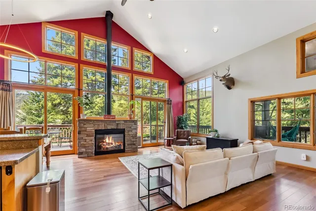 a living room with furniture a fireplace and a large window