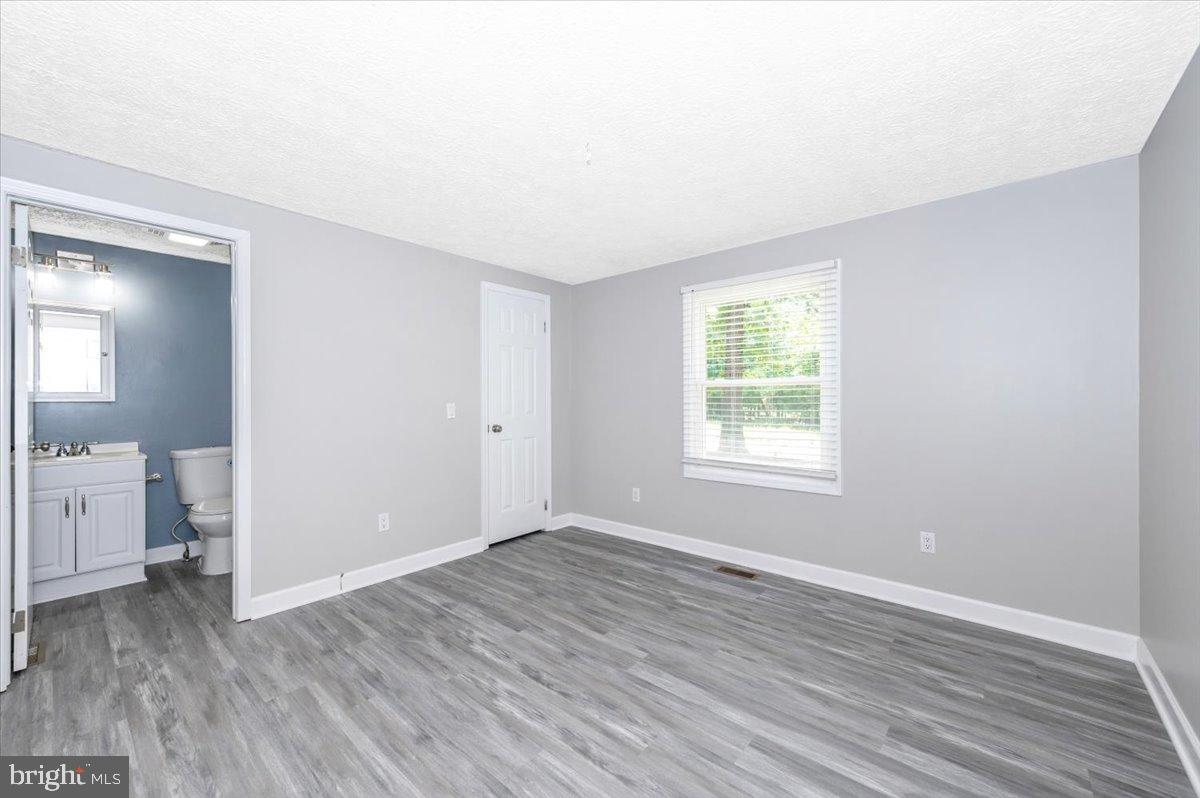 12284 Bandera Lane Lusby, MD 20657 - Photo 20 of 55 an empty room with wooden floor and windows