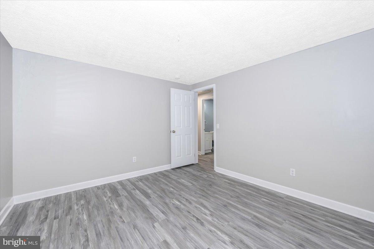 12284 Bandera Lane Lusby, MD 20657 - Photo 21 of 55 a view of an empty room with wooden floor