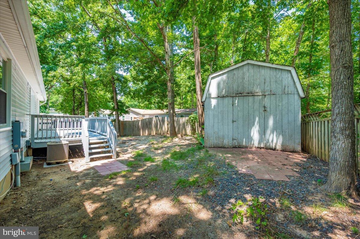 12284 Bandera Lane Lusby, MD 20657 - Photo 41 of 55 a backyard of a house with barbeque oven and outdoor seating