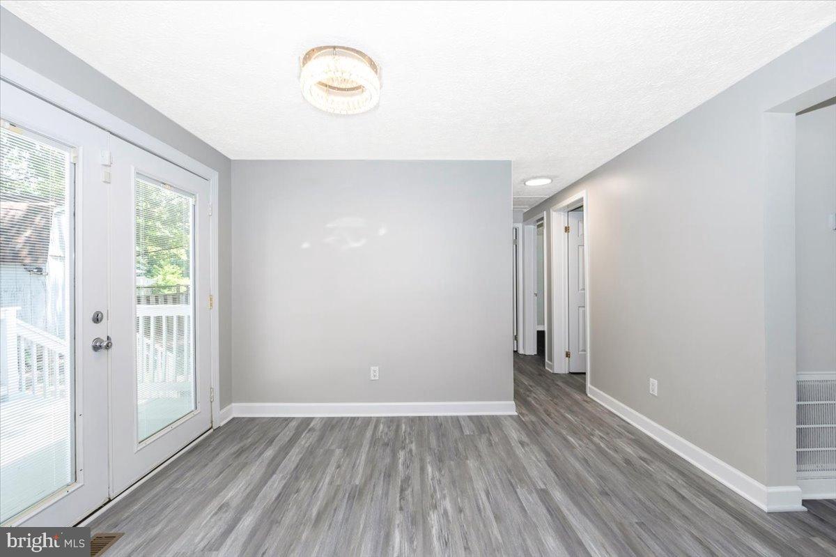 12284 Bandera Lane Lusby, MD 20657 - Photo 10 of 55 a view of an empty room with wooden floor and a window