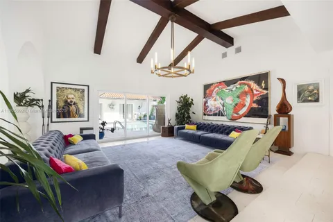 a living room with furniture gym equipment and a rug