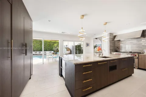a kitchen with stainless steel appliances granite countertop a sink and stove
