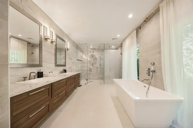 a large bathroom with a large tub sink shower and mirror