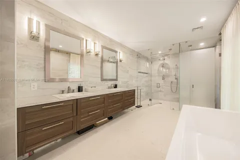a spacious bathroom with double vanity shower and a bathtub