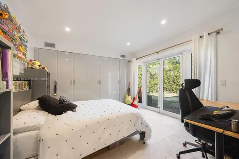 a bedroom with a bed and a desk