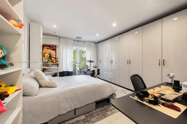 a spacious bedroom with a bed and a large window