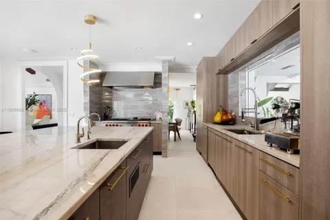 a kitchen with stainless steel appliances granite countertop a sink and a stove