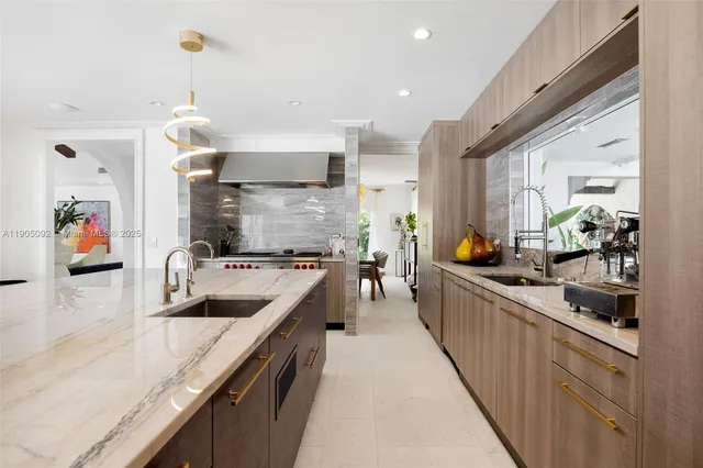 a kitchen with stainless steel appliances granite countertop a sink and a stove