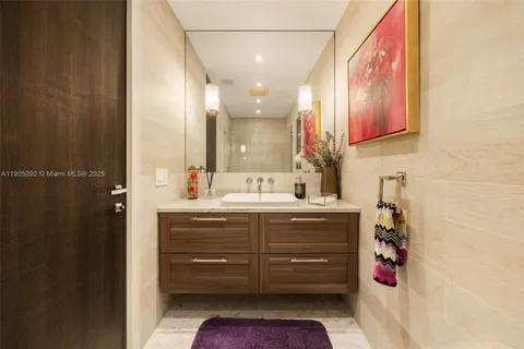 a bathroom with a sink vanity and a mirror