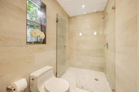 a bathroom with a toilet and a shower