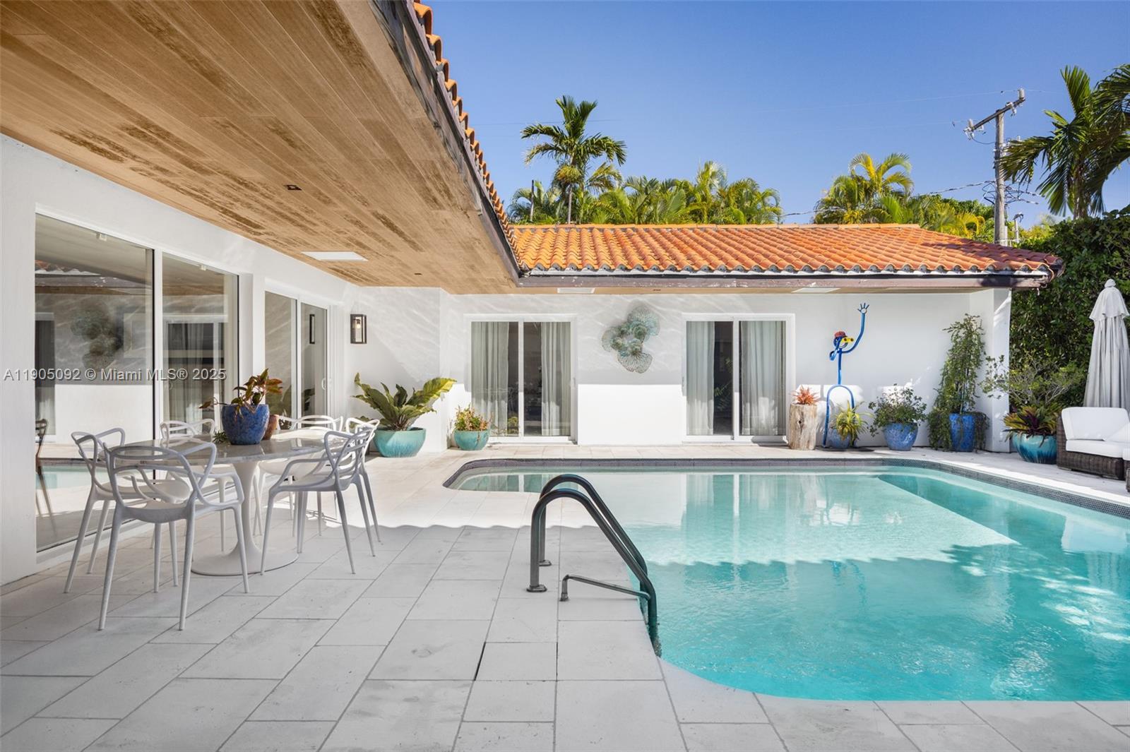 1233 102nd Street Bay Harbor Islands, FL 33154 - Photo 37 of 52 a view of a swimming pool with a patio