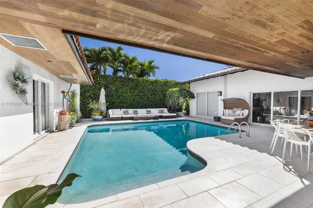 a view of a house with a yard and potted plants