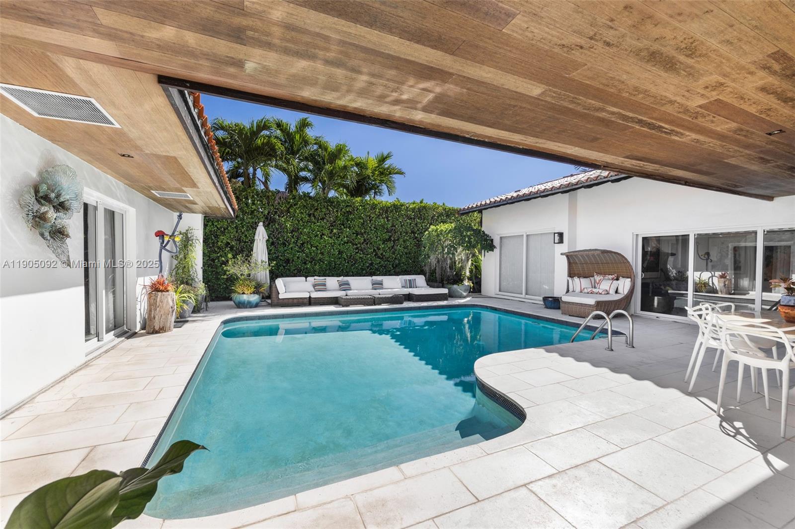 1233 102nd Street Bay Harbor Islands, FL 33154 - Photo 39 of 52 a view of a patio with swimming pool table and chairs