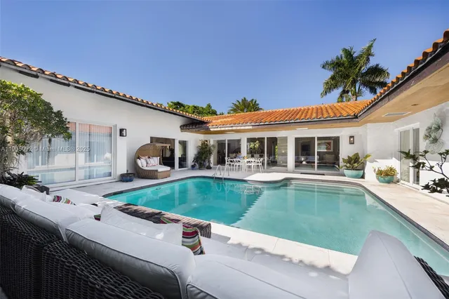 a view of a house with swimming pool and a porch