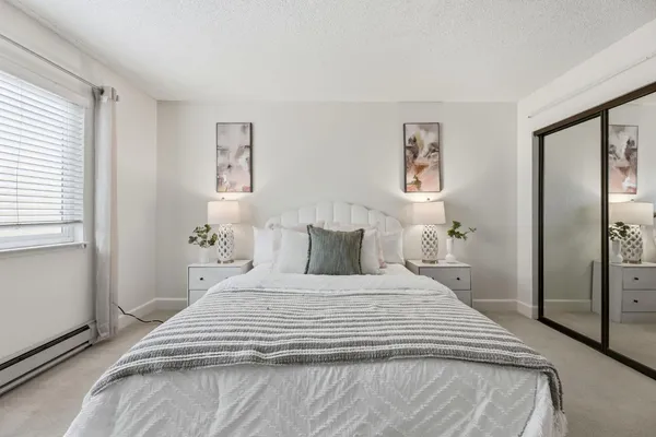 a bedroom with a bed and a window