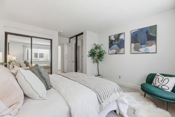 a bedroom with a bed and a couch
