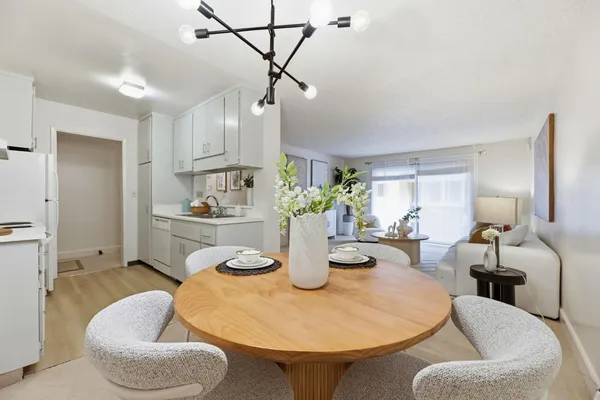 a kitchen with stainless steel appliances kitchen island granite countertop a couch and chairs