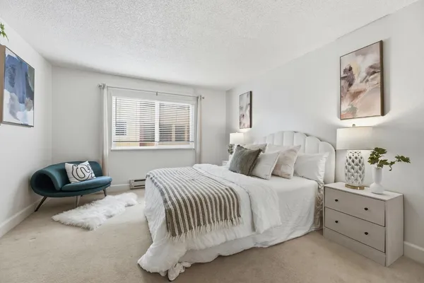 a bedroom with a bed and a couch