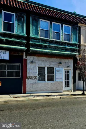 a front view of a house with a garden and plants