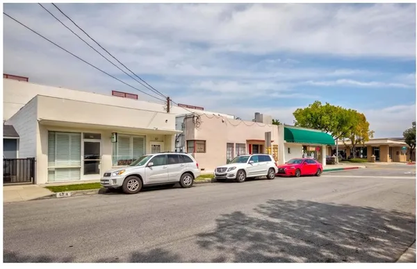 a view of a cars park in front of a building