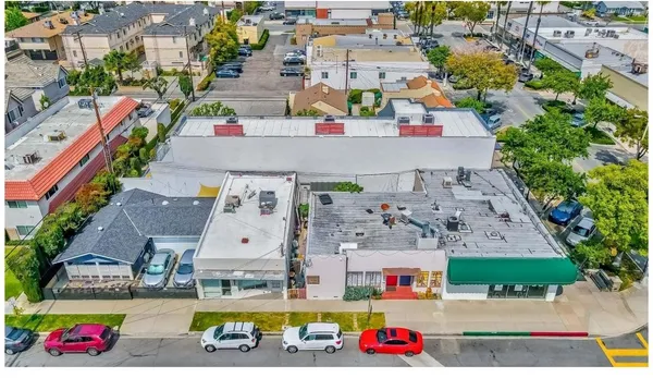 an aerial view of multi story residential apartment building with yard