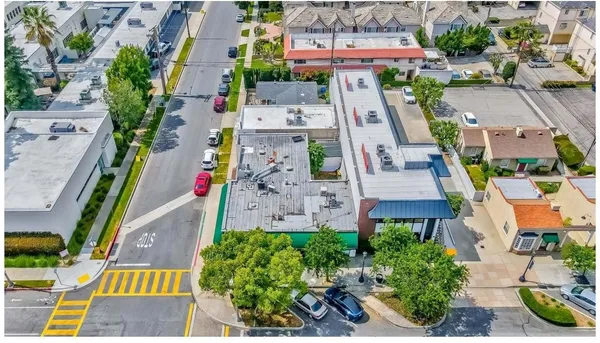 an aerial view of multiple houses with yard