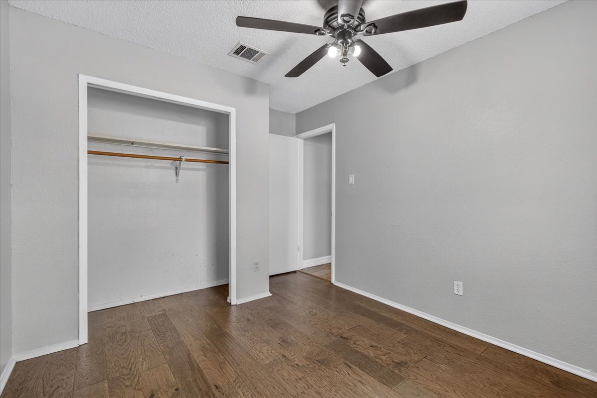6200 Shadow Bend Austin, TX 78745 - Photo 21 of 33 Hardwood floors and a ceiling fan create a comfortable atmosphere in this inviting bedroom.